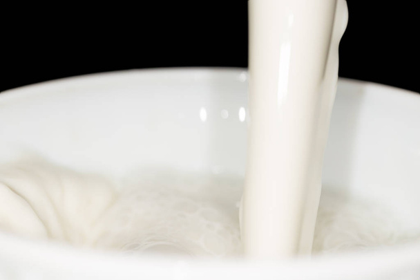 milk splash on black background - Foto, imagen