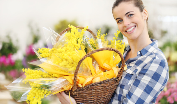 smiling woman with basket full of mimosa spring flowers, 8 March Women's Day concept - Photo, Image