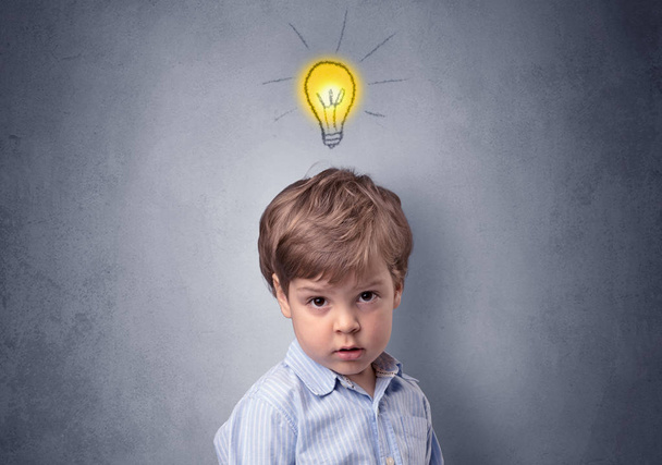 Little boy mull over with bulb above his head - Photo, Image