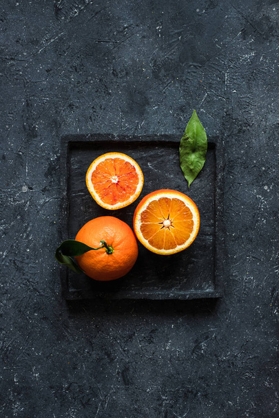 Orange fruit background. Blood orange fruits on gray background top view. - Photo, image