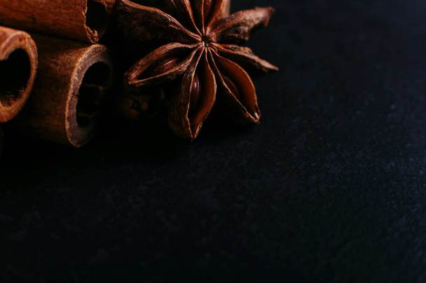 Spices sticks cinnamon and star anise on old table. Rustic dark background, aroma close-up, macro. - Valokuva, kuva