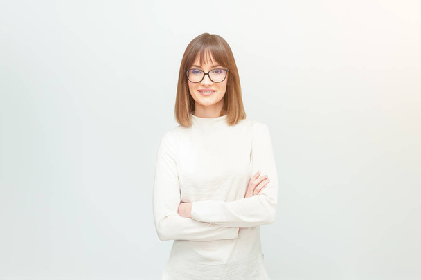 Beautiful young woman with glasses, dressed as casual, on a gray background.  Office worker.Designer. - Fotoğraf, Görsel