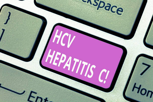 Signo de texto que muestra Hcv Hepatitis C. Foto conceptual Enfermedad hepática causada por un virus enfermedad crónica grave Teclado clave Intención de crear mensaje de ordenador presionando el teclado idea
. - Foto, Imagen