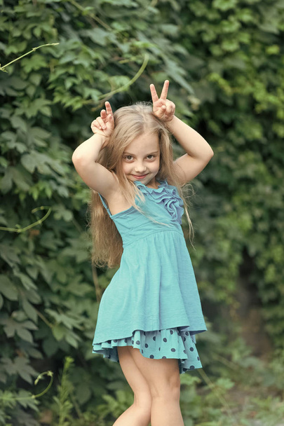 Small girl with long hair smile with horns hands, beauty - Foto, imagen