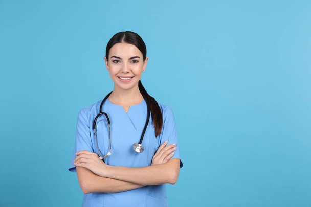 Portrait of medical assistant with stethoscope on color background. Space for text - Fotografie, Obrázek