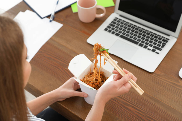 Empleado de oficina almorzando fideos en el lugar de trabajo, primer plano. Entrega de alimentos
 - Foto, Imagen