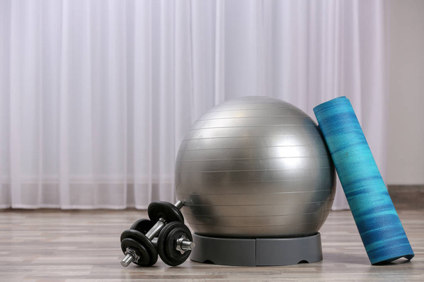 Set of fitness equipment on floor indoors. Space for text - Fotó, kép