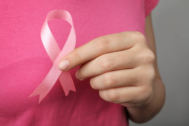 Woman holding pink ribbon, closeup. Breast cancer awareness - Fotografie, Obrázek