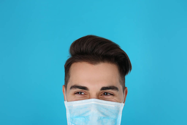Young medical student with face mask on color background, closeup - Foto, immagini
