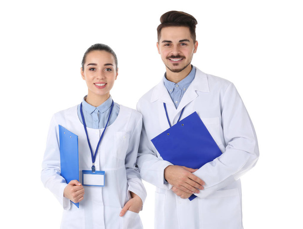 Happy young medical students on white background - Fotoğraf, Görsel