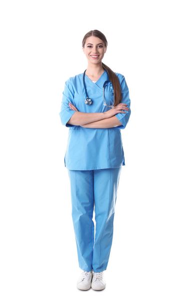 Young medical student in uniform on white background - Фото, зображення