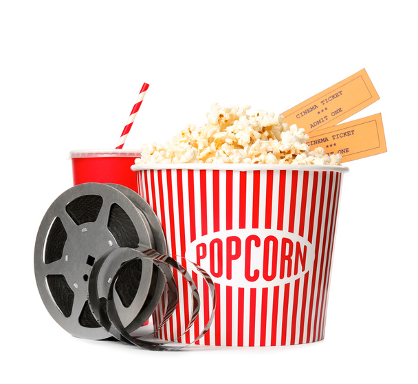 Popcorn bucket, tickets and reel isolated on white. Cinema snack - Photo, Image