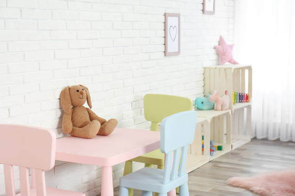Cozy kids room interior with table, chairs and toys - Foto, immagini