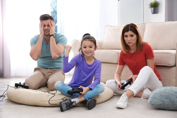 Happy family playing video games in living room - Foto, imagen