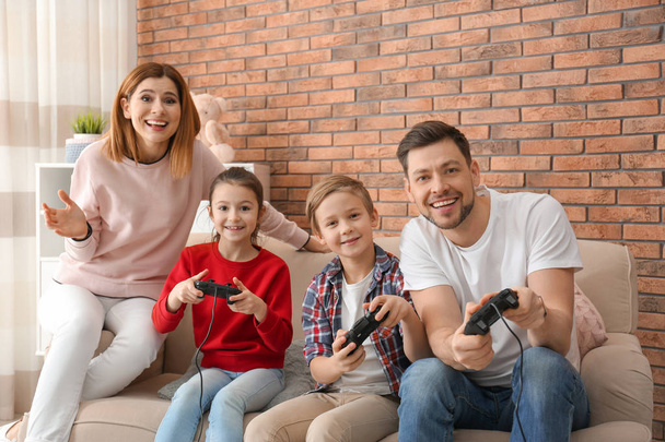 Happy family playing video games in living room - Foto, immagini