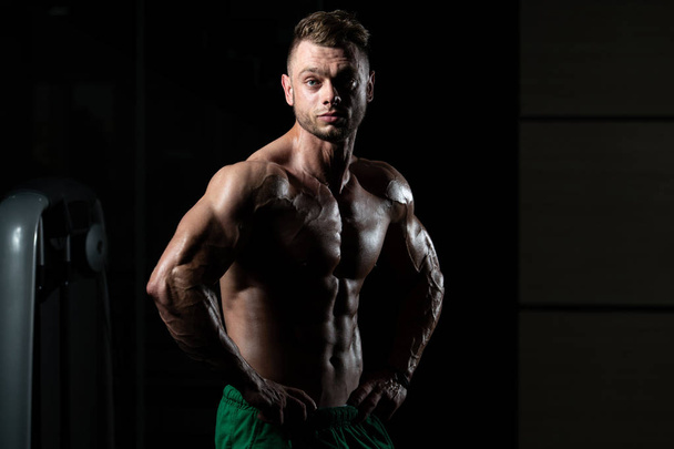 Portrait Of A Young Physically Fit Man Showing His Well Trained Body - Muscular Athletic Bodybuilder Fitness Model Posing After Exercises - Foto, immagini