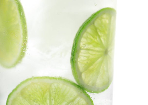 Drink with lime and ice cubes isolated on white, closeup - Фото, зображення