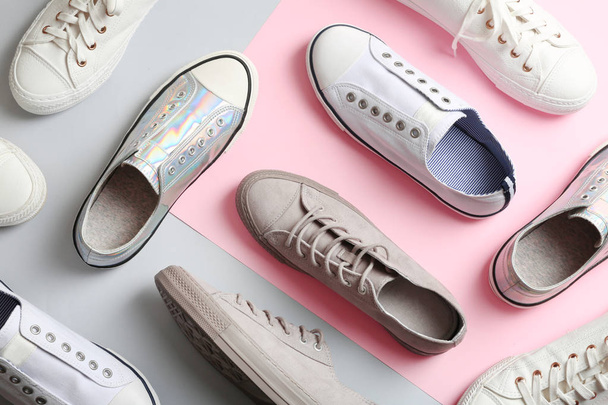 Flat lay composition with different sneakers on color background - Fotografie, Obrázek