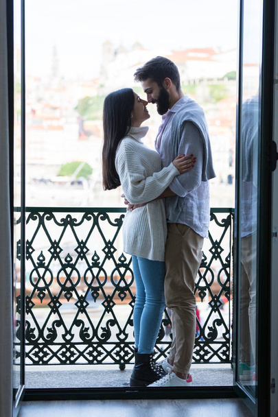 Young couple relaxing at the balcony of their new house. - Foto, Imagen