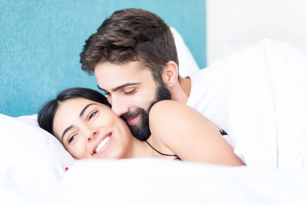 A beautiful young passionate couple in bed - Photo, Image