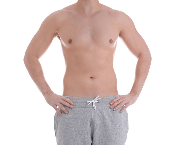 Young athletic man on white background, closeup. Weight loss - Photo, Image