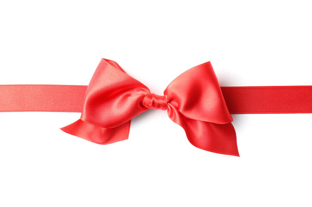 Red ribbon with bow on white background. Festive decoration - Fotoğraf, Görsel
