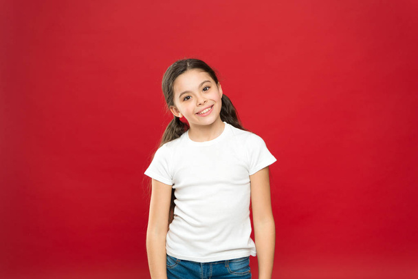 Kid happy cute face feels excited red background. Exciting moments. Excitement emotion. Sincere excitement. Kid girl long healthy shiny hair wear casual clothes. Little girl excited smiling face - Photo, Image