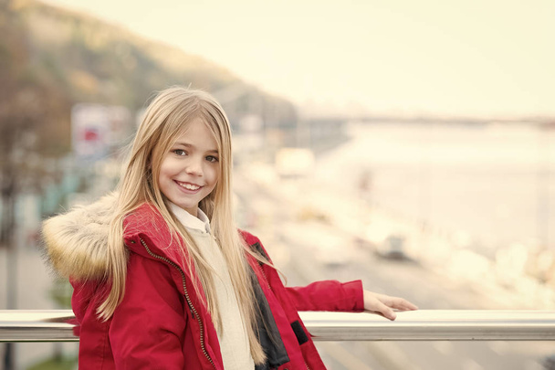Child in red coat stand on bridge - Фото, зображення