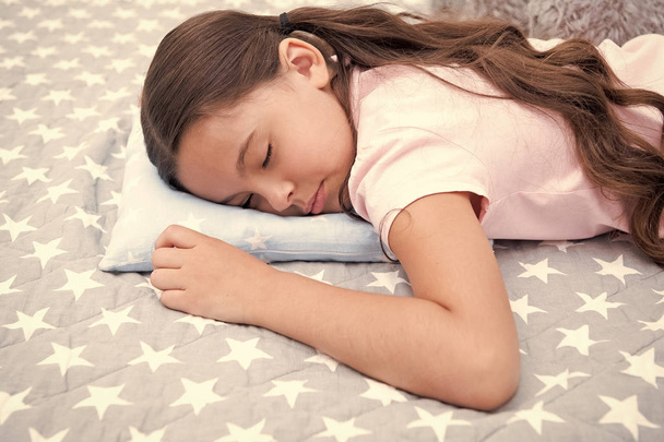 Healthy sleep tips. Girl sleeps on little pillow bedclothes background. Girl child long hair fall asleep pillow close up. Quality of sleep depends on many factors. Choose proper pillow to relax well - 写真・画像