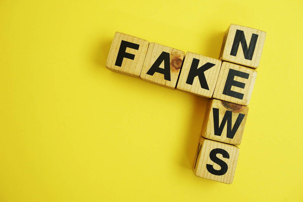 Fake News word alphabet letters on yellow background - Photo, Image