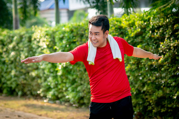 Happy Asian sport man doning exercise in the park outdoor. - Photo, Image