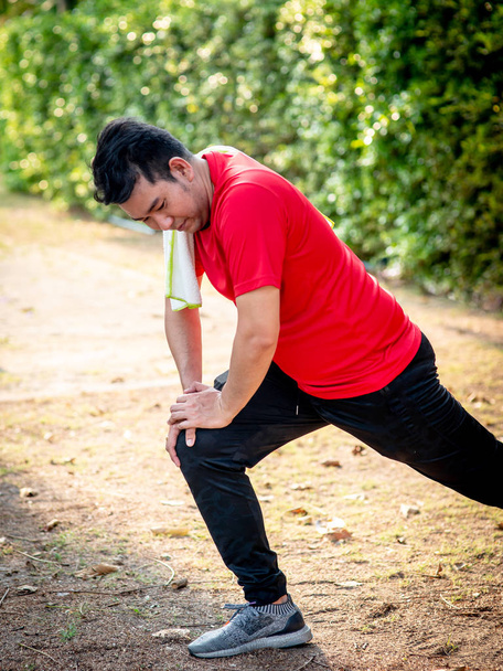 Happy Asian sport man doning exercise in the park outdoor. - Photo, image