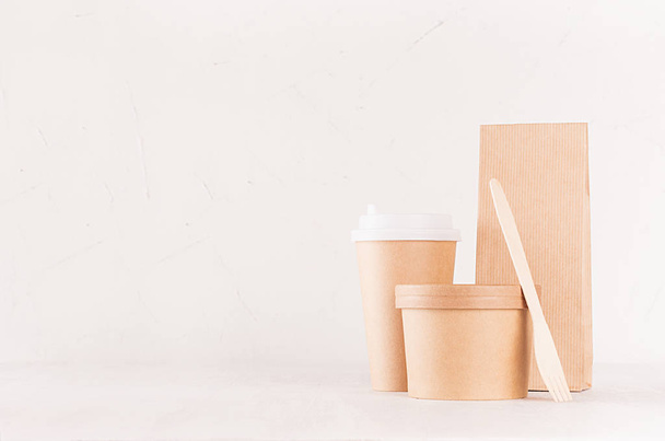 Set of cardboard package for different fast food for advertising, menu, banding identity - blank bowl for soup or ice cream, drink cup, packet, fork on white wooden background. - Foto, Imagem