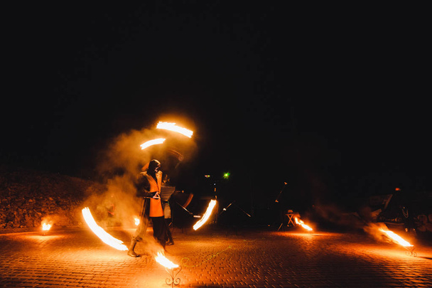 man performing dance with fire at night  - Foto, imagen