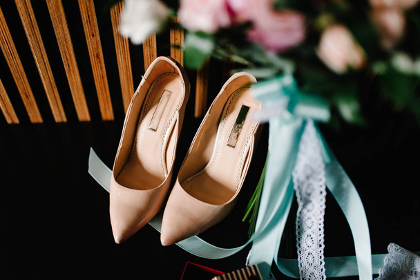 stylish bride shoes, wedding bouquet with flowers and ribbons - Photo, Image