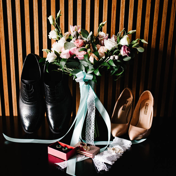 stylish bride and groom shoes, wedding bouquet, ribbons and gold wedding rings in box - Photo, Image