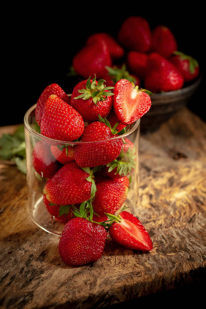 Ripe red strawberries on dark wooden background. - Photo, Image