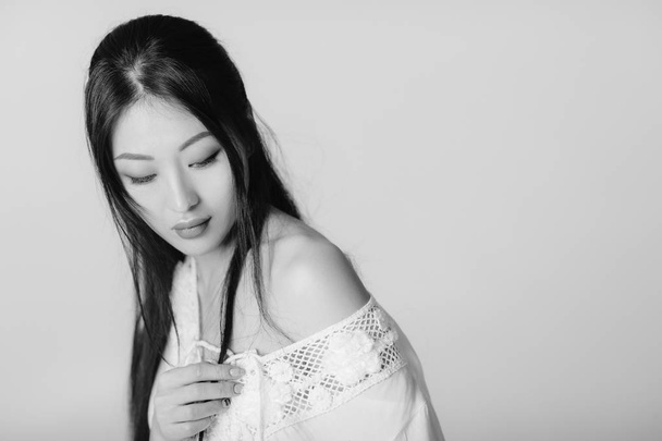 beautiful asian woman in white shirt posing in studio. - Photo, image