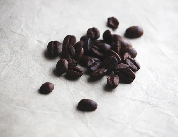 Coffee beans on old crumpled craft paper texture - Fotó, kép