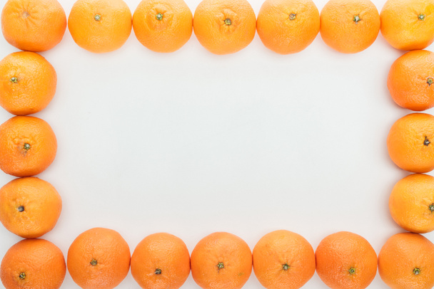 frame borders of ripe tangerines on white background with copy space - Фото, изображение