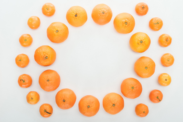 round frame of ripe orange tangerines on white background with copy space - 写真・画像
