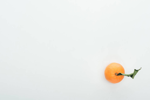 bright ripe orange tangerine with green leaves on white background with copy space - Photo, image