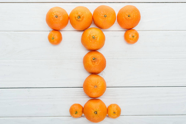 top view of letter T made of fresh tangerines on wooden white background - Фото, зображення