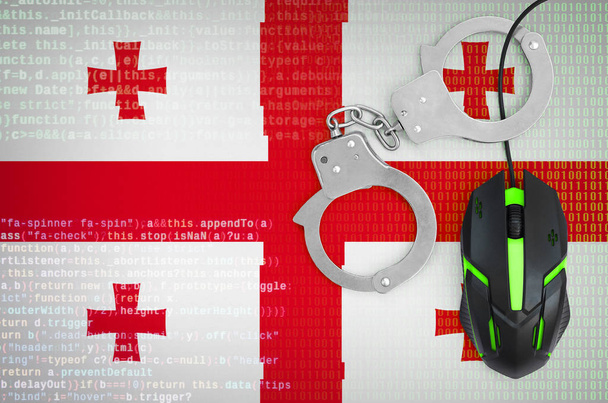 Georgia lippu ja käsiraudoissa moderni taustavalaistu tietokoneen hiiri. Tietokonerikollisuuden, hakkereiden ja piratismin torjunnan luova käsite
 - Valokuva, kuva