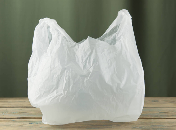 Clear disposable plastic bag on a wooden table close-up - Fotó, kép