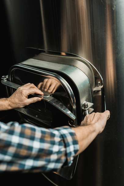 男性のビール醸造所装置の操作のビューをトリミング - 写真・画像