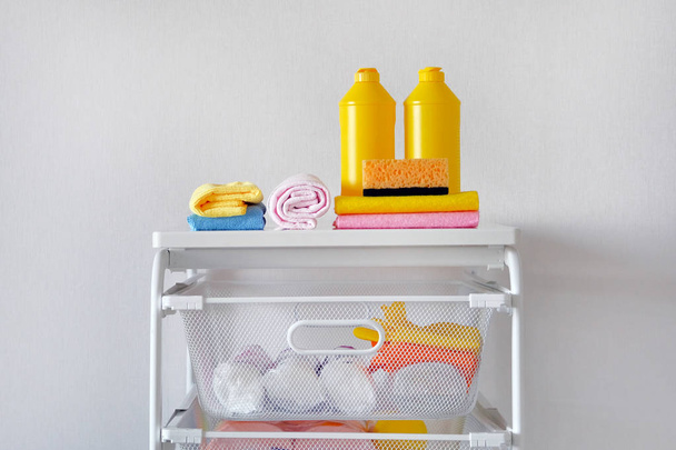 Detergent for cleaning room. Cleaning concept. Yellow plastic bottles with cleaning agent and tools. Regular washing. - Photo, Image