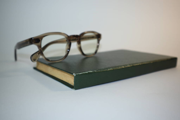 old book and glasses on white background - Foto, Imagem