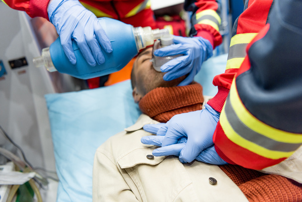 Cropped view of paramedics doing cardiopulmonary resuscitation - Foto, immagini