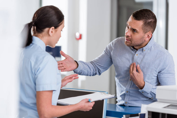 Stressed patient talking to nurse in clinic - Photo, image